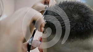 Men`s hairstyle and haircut at the hairdresser. Hair care. Barbershop. Woman hairdresser doing hairstyle to adult man