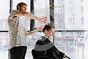 Men`s hairstyling and haircutting in a barber shop or hair salon