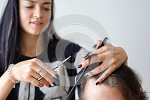 Men's hairstyling and haircutting in a barber shop or hair salon