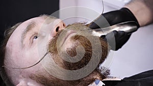 Men`s hairstyling and haircutting in a barber shop or hair salon.