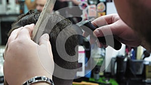 Men`s hairstyling and haircutting in a barber shop or hair salon. Grooming the hair. Barbershop. Men hairdresser doing