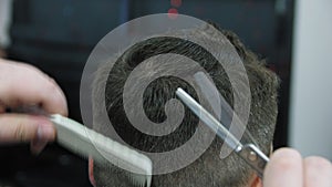 Men`s hairstyling and haircutting in a barber shop or hair salon. Grooming the hair. Barbershop. Men hairdresser doing