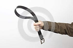 Men`s hand with black waist leather belt on white background