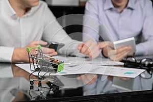 Men`s hands with calculator and phone on the background of the documents on the table