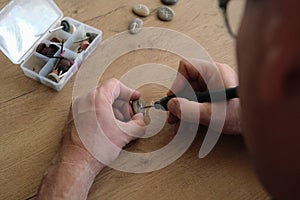 men& x27;s hands carve handmade runes