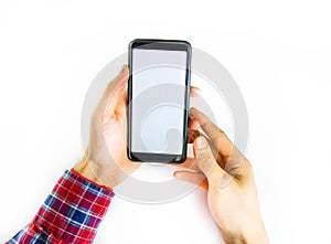 Men`s hands in a checkered hipster shirt are holding a smartphone on a white background. The screen is white and black. Hands