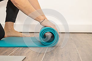 Men& x27;s hands close-up, unroll colorful mat for playing sports. Sport and healthy lifestyles concept