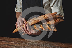 Men`s hands hold baguettes