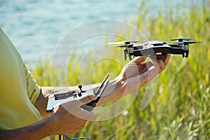 Men`s hands that hold drone close-up