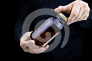 Men`s hands hold a jar of fish oil capsules