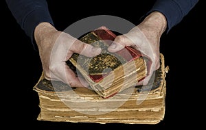 Men`s hands hold the old book