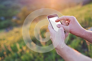 Men's hands hold the phone and touch the screen