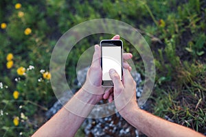 Men's hands hold the phone with the white screen and touch displ