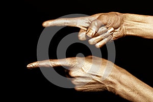 Men's hands indicate in the gold make-up photo