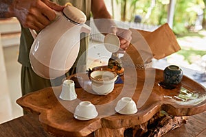 Men`s hands pour Chinese tea