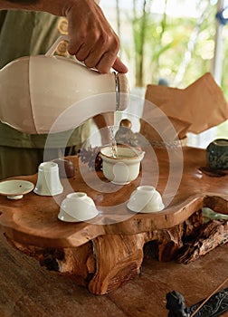 Men`s hands pour Chinese tea