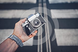 Men`s hands with a retro camera