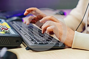 Men& x27;s hands type on a computer keyboard. remote work and online learning.