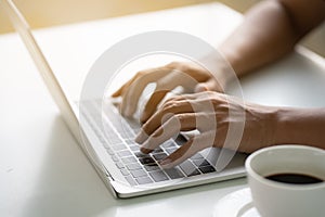 Men`s hands are typing on the laptop