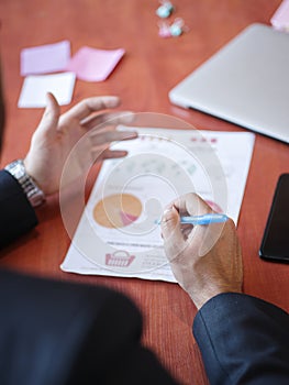 Men`s hands work with documents on the wooden table. Business concept.