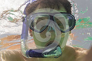 Men`s head in a blue snorkeling mask