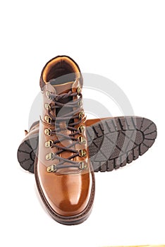 men's leather brown boots for winter or autumn hiking on a white background. Men's fashion, trendy shoes. Close-up