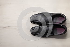 Men`s leather shoes on wood background