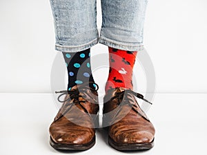 Men`s legs in bright, colorful socks and stylish shoes