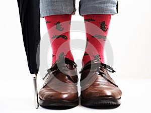 Men`s legs in bright socks and stylish shoes