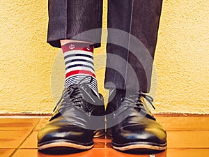 Men`s legs, stylish shoes and colorful socks