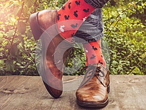 Men`s legs in stylish shoes and funny socks
