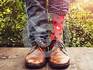 Men`s legs in stylish shoes and funny socks