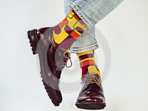 Men`s legs, trendy shoes and bright socks