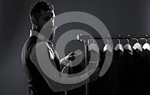 Men`s lothing, shopping in boutiques. Tailor, tailoring. Man suit, tailor in his workshop. Elegant man`s suits hanging