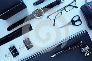 Men`s office supplies and accessories on a gray table.