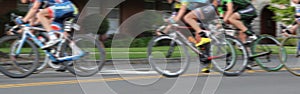 Men\'s Professional Cycling Race with Motion Blur Panning. Panorama header crop for landscape copy space.