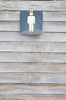 Men`s restroom signs on old wood photo