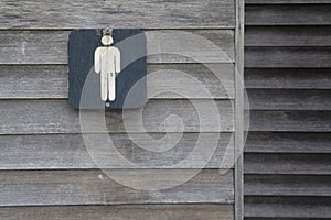 Men`s restroom signs on old wood photo