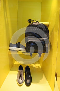 Men's shoes and accessories, shop window on a yellow background. Fashionable men's clothing.