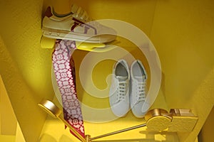 Men's shoes and accessories, shop window on a yellow background. Fashionable men's clothing.