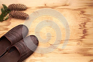 Men's slippers on the wooden table