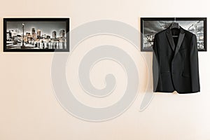 The men`s suit hangs in the picture on the right. there is space for text. Businessman`s morning