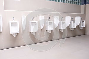 Men`s toilet public with white porcelain urinals stall, Modern  clean bathroom for a pee