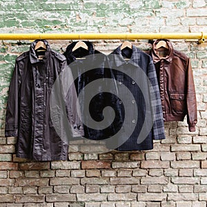Men's trendy clothing on hangers photo