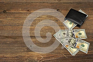 Men's Wallet With Dollar Cash On The Rough Wood Background