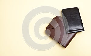 Men`s wallets on an isolated yellow background