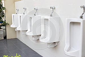 Men`s white urinals design, Close up row of outdoor urinals men public toilet