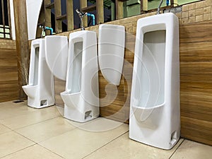 Men`s white urinals design, Close up row of outdoor urinals men public toilet