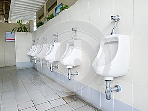 Men`s white urinals design, Close up row of outdoor urinals men public toilet