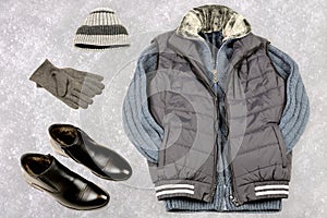 Men`s winter clothing on the background of snow